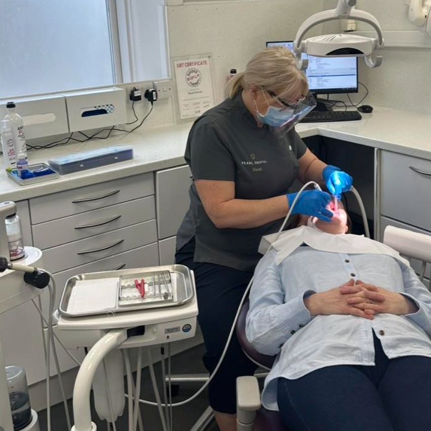 Hygienist Hazel Jackson treating a patient in the chair