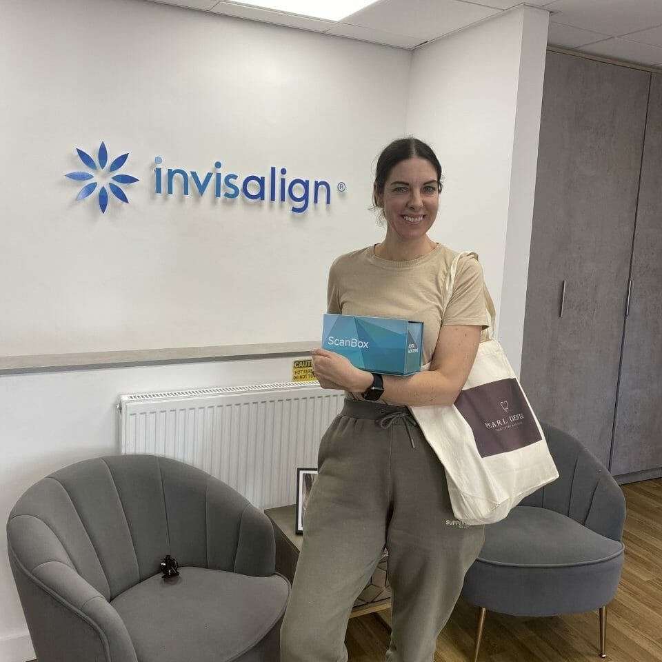 A patient holding an Invisalign ScanBox in the practice’s Invisalign zone