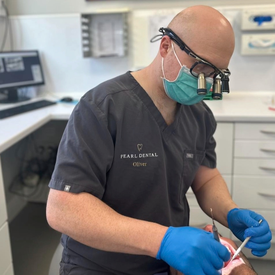 Dr Oliver Kenyon treating a patient wearing loupes