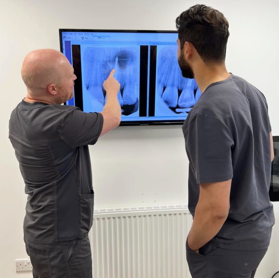 Two Pearl Dental clinicians reviewing an x-ray on screen